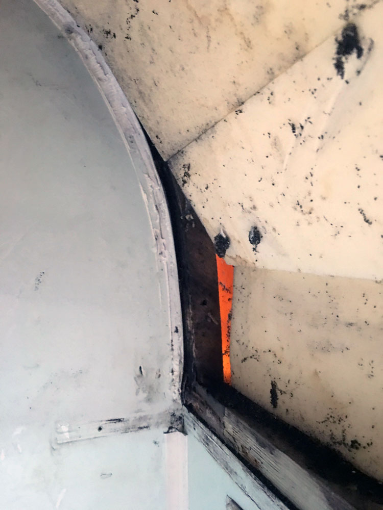 Removal of ceiling board to reveal damp timber